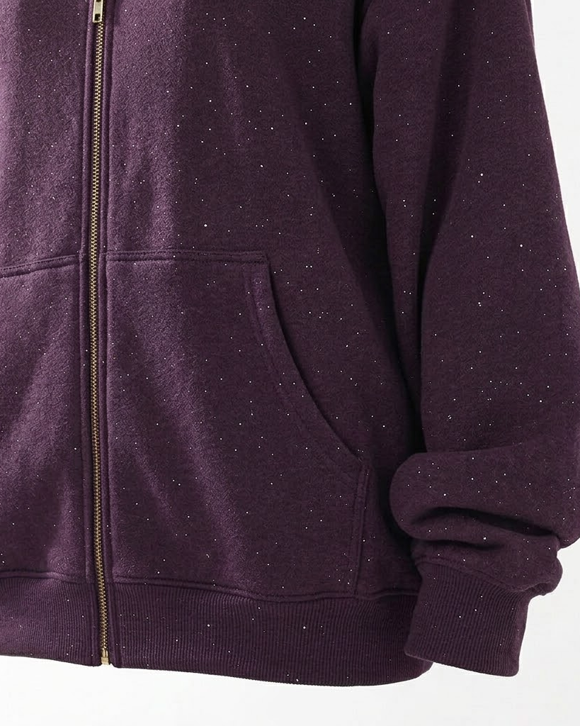 Close-up of the purple hoodie kangaroo pocket, gold zipper and ribbed hem