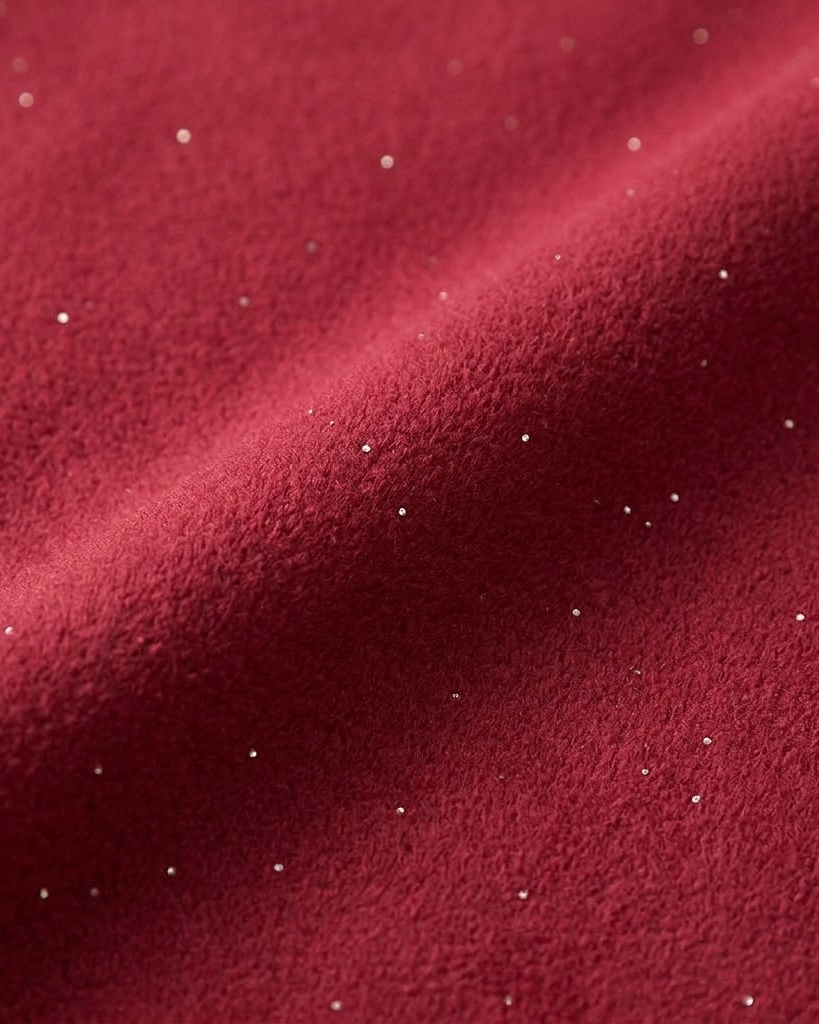 Close-up of red sparkle fleece fabric with fine metallic flecks